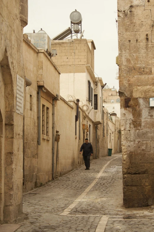 a man walking on the street of an old city