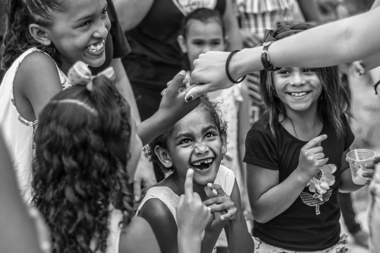 a group of s standing around each other with their hands over the mouth