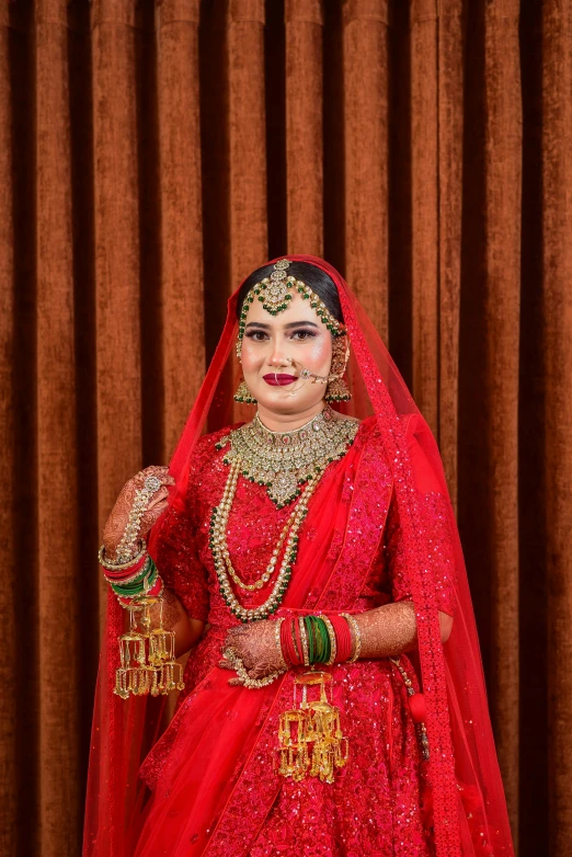 a woman in red is dressed for her wedding