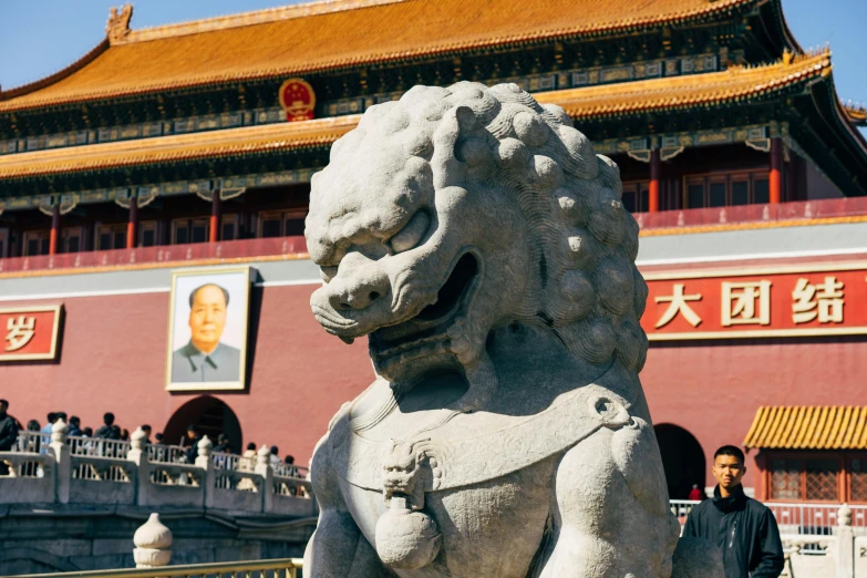 there is a stone statue at the entrance to a building