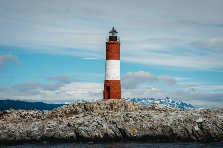 a large light house on top of a rocky cliff