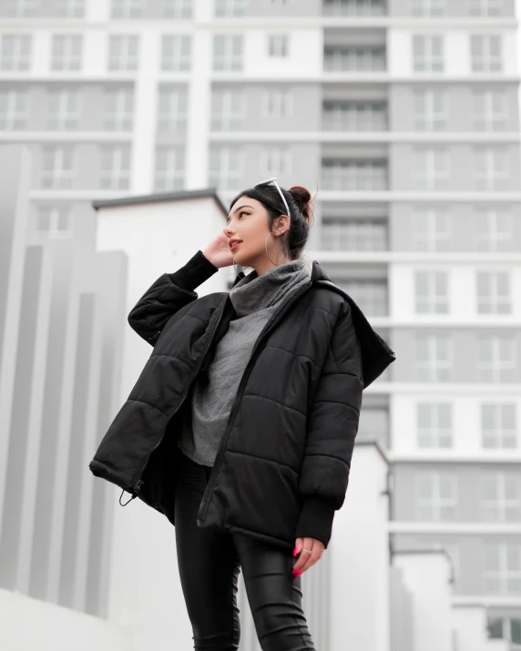 young woman in black jacket posing for the camera