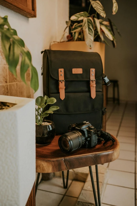 a dark bag sitting on top of a wooden table