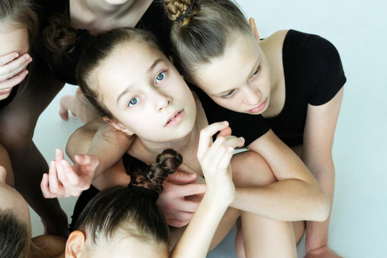 the group of girls are standing together and looking up