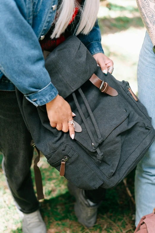 two people holding bags of luggage together