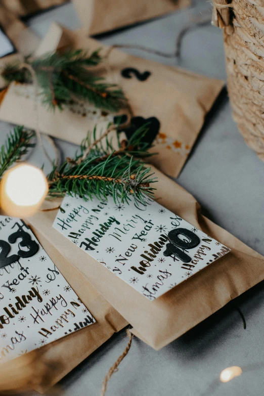 christmas themed place cards set next to a candle