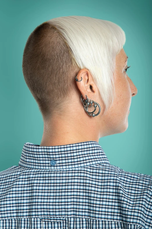 a woman with a short white hair is in profile