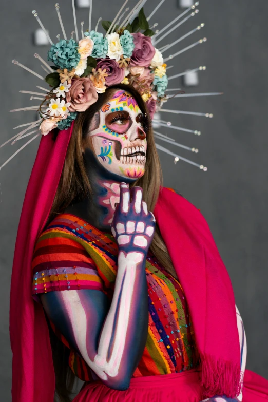 a woman is covered in painted sugar skull makeup