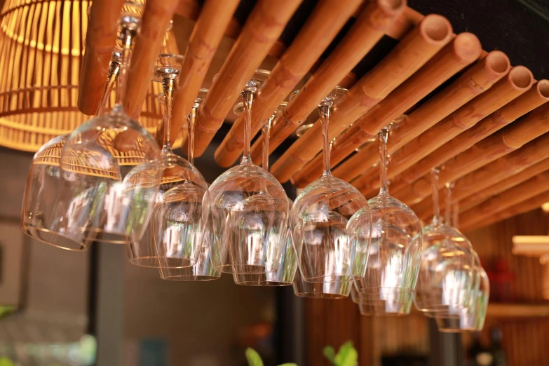 small wine glasses are sitting under a wine glass rack