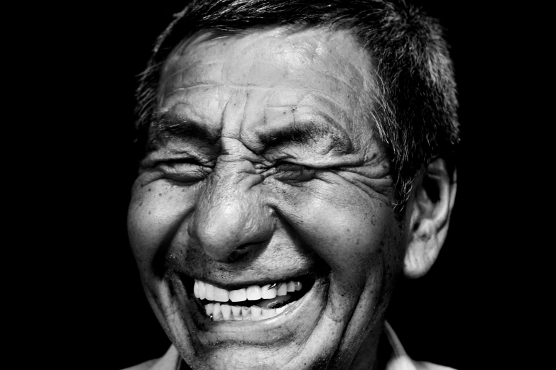 an older man laughing with his mouth wide open