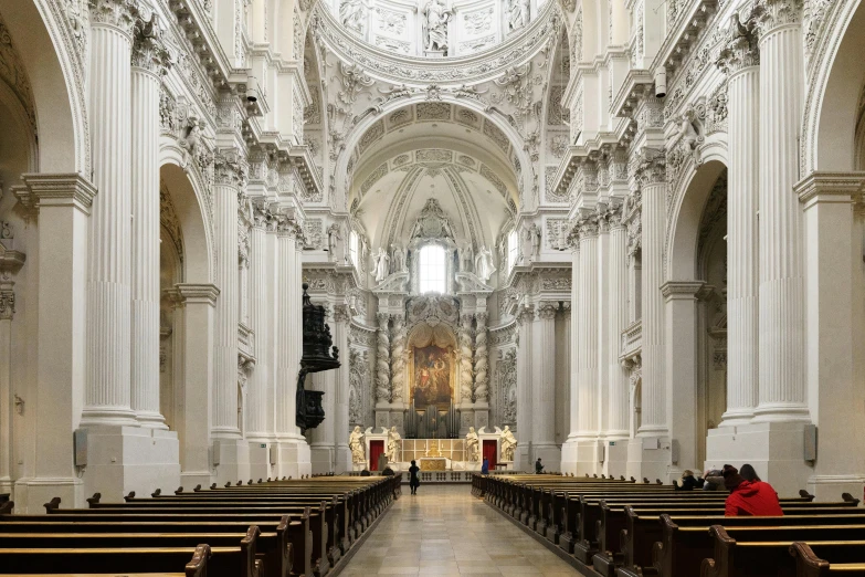 a very large and elaborate cathedral has a few pews