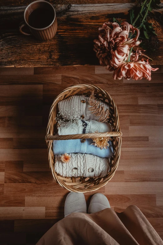 socks and a coffee are placed next to a basket