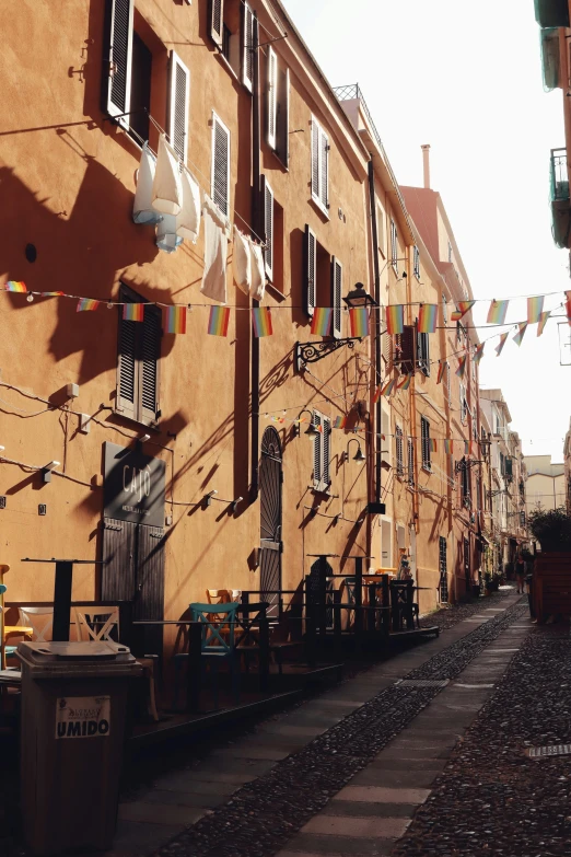 two buildings are shown and there is a garbage can