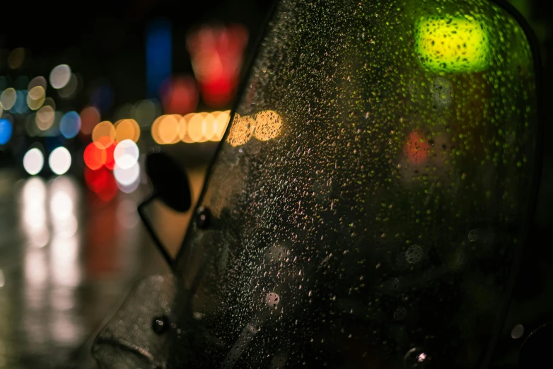 street lights and rain drops shining on the glass