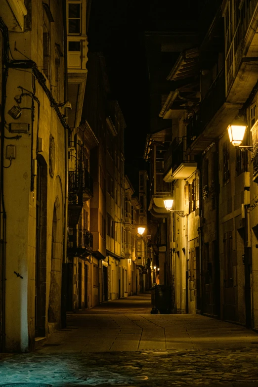 a woman sits alone in the dark on a city street at night