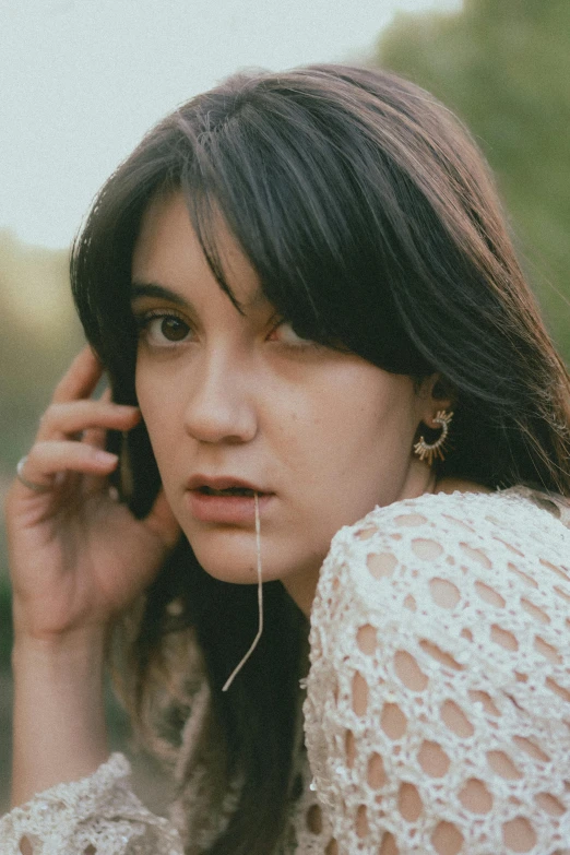 the woman is talking on her cellphone outdoors