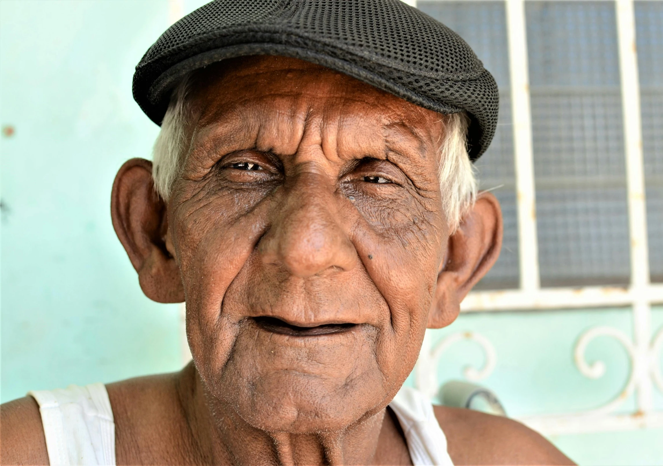 an old man with a black hat and eyes