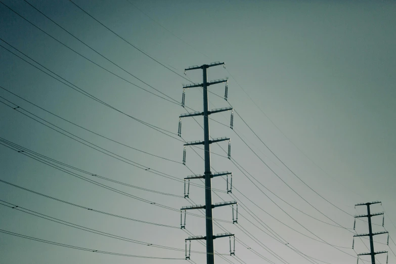 telephone wires are hanging from wires on a pole