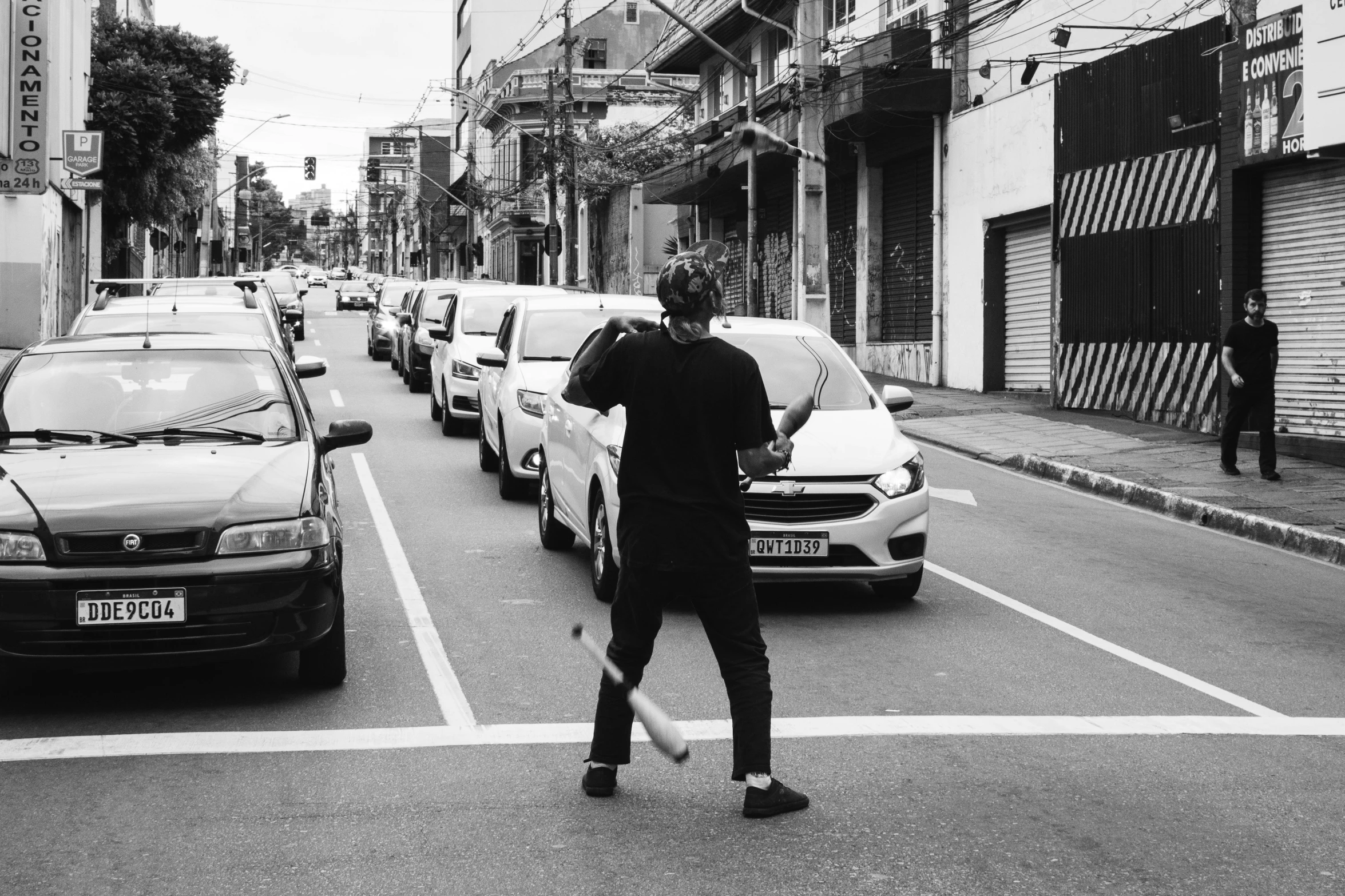 a man is standing in the middle of a busy street holding an umbrella