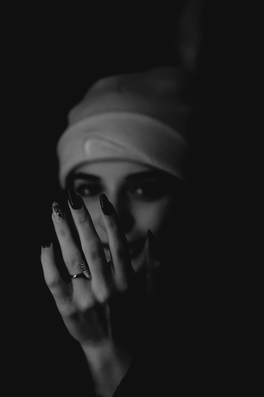 a black and white po of a woman covering her face