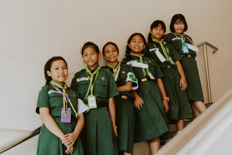 the girls in uniforms have medals around their necks