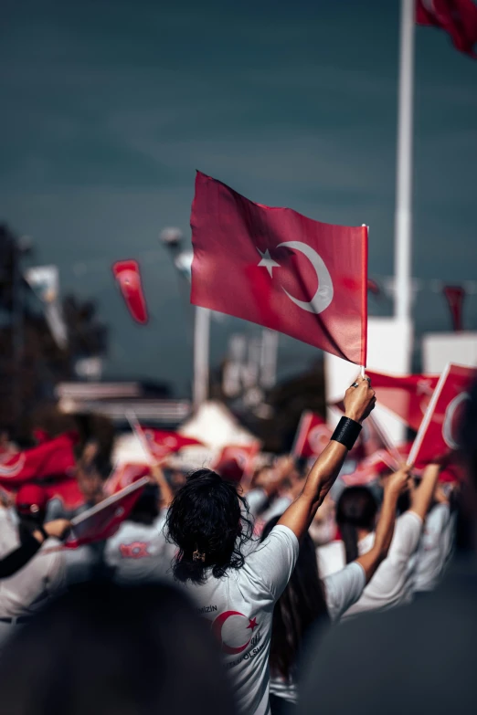 people with flags in front of a building