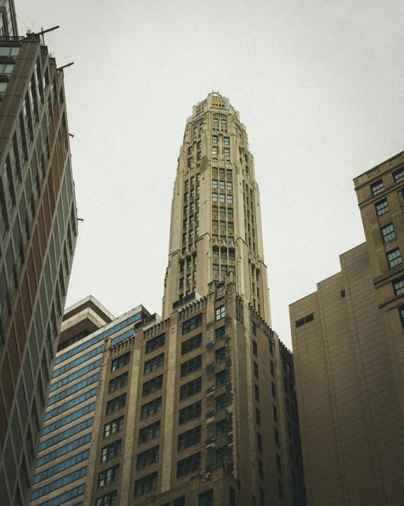 an upward view of some tall buildings from the ground