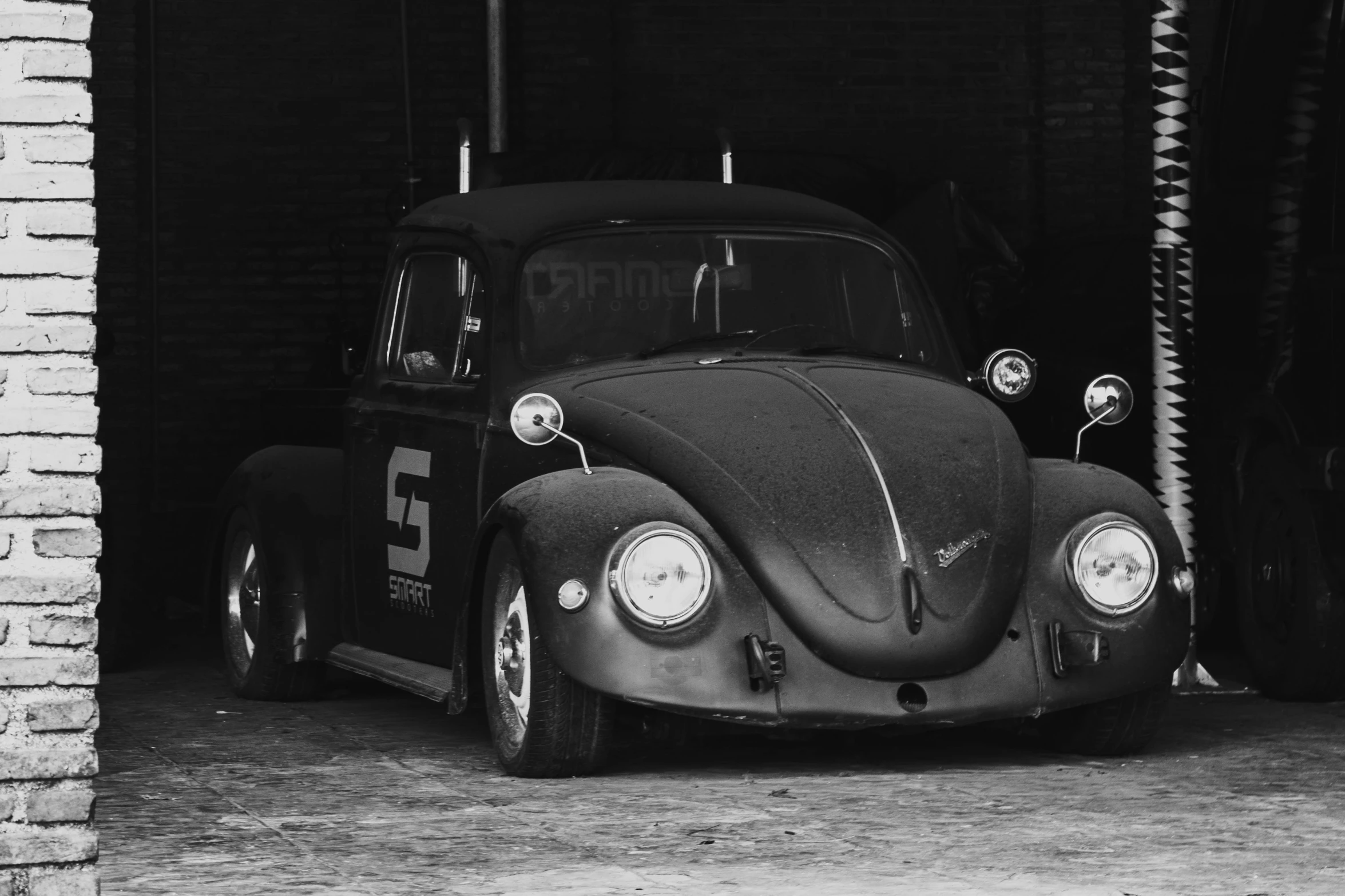 a classic bug is parked in a garage