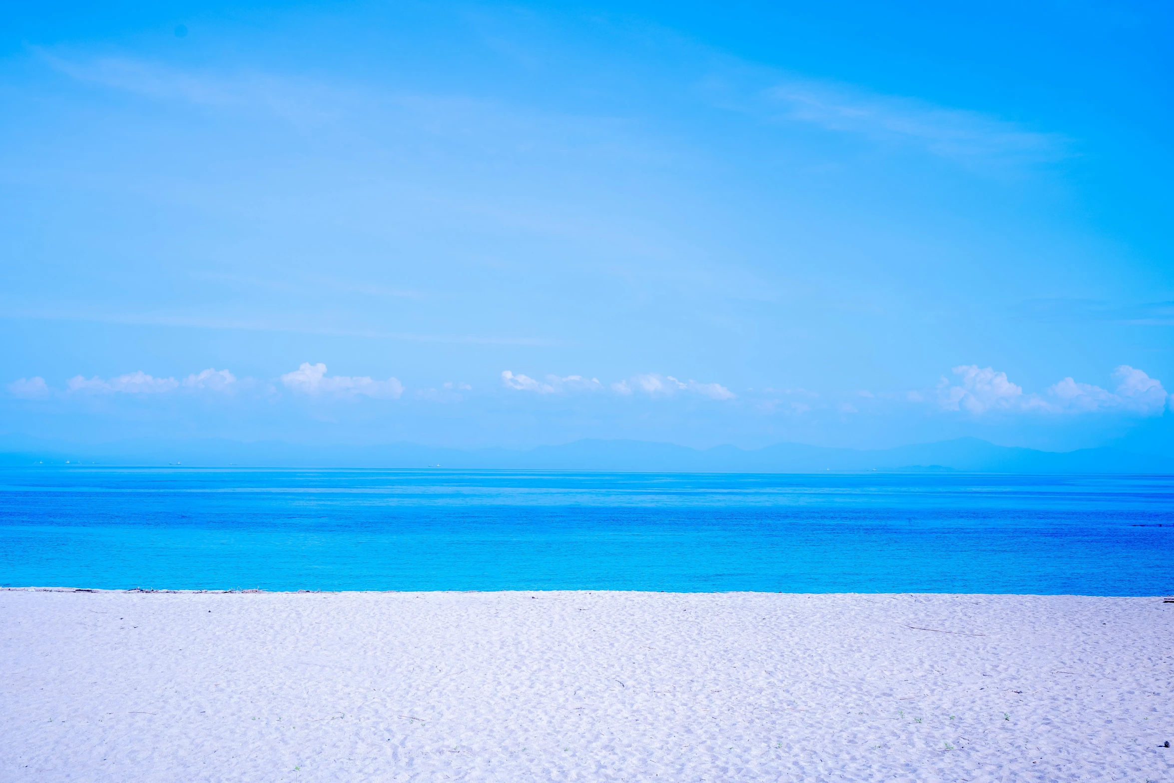 the white sand on the beach has blue water