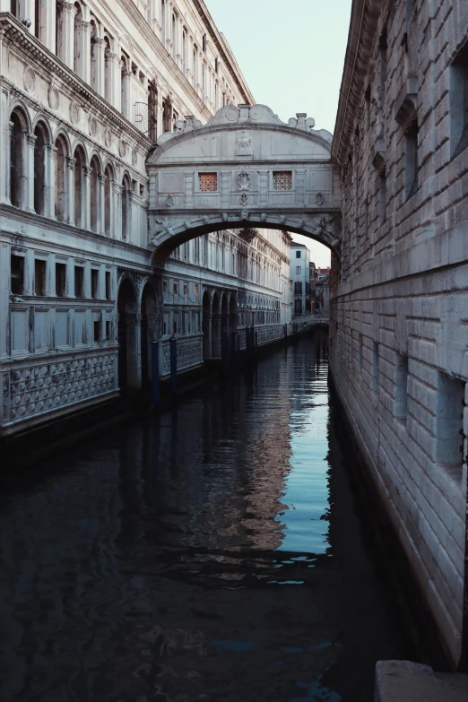 a bridge is going over some water and another bridge has the doors open