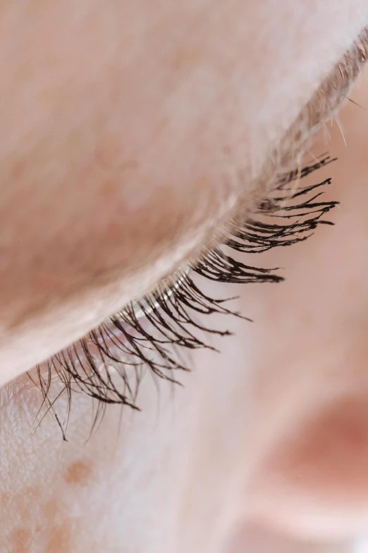 a woman is showing off her extreme long eyelashes