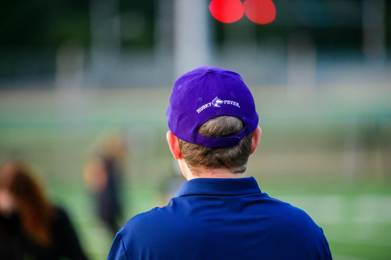 the back of a man's head looking towards a red traffic light