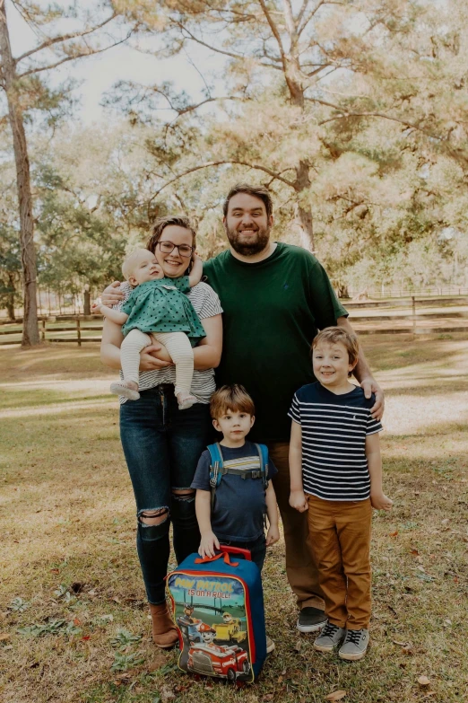 two adults and three children are posing for a picture