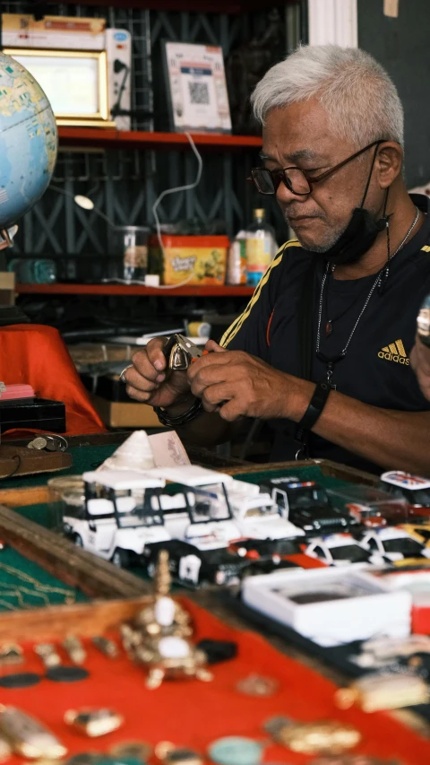 an old man working on a piece of architecture