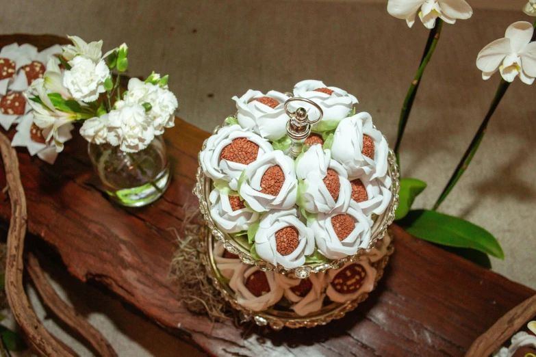 some pretty flowers are arranged next to a table