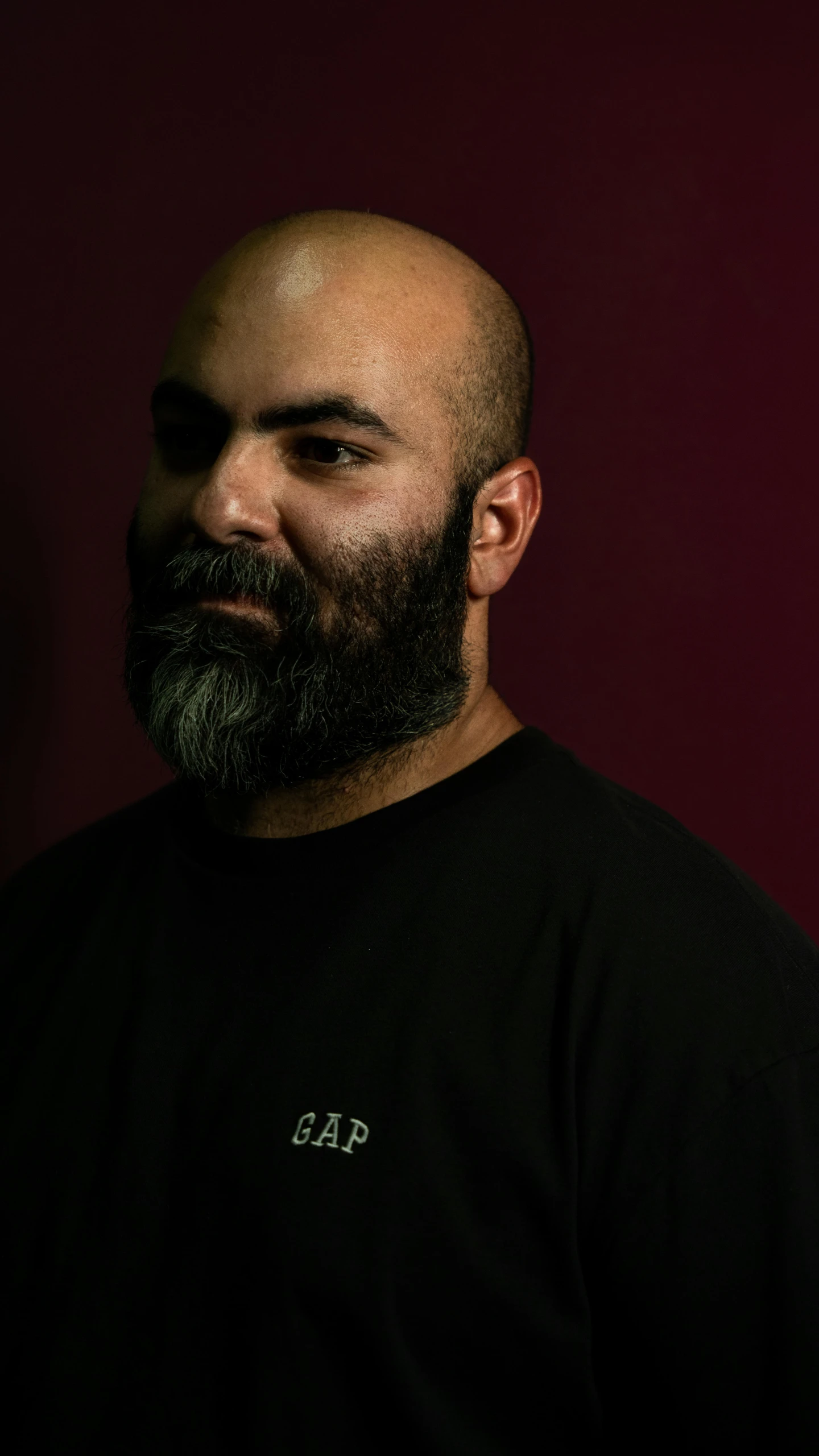 a man with a beard wearing a t - shirt with the word gap on it