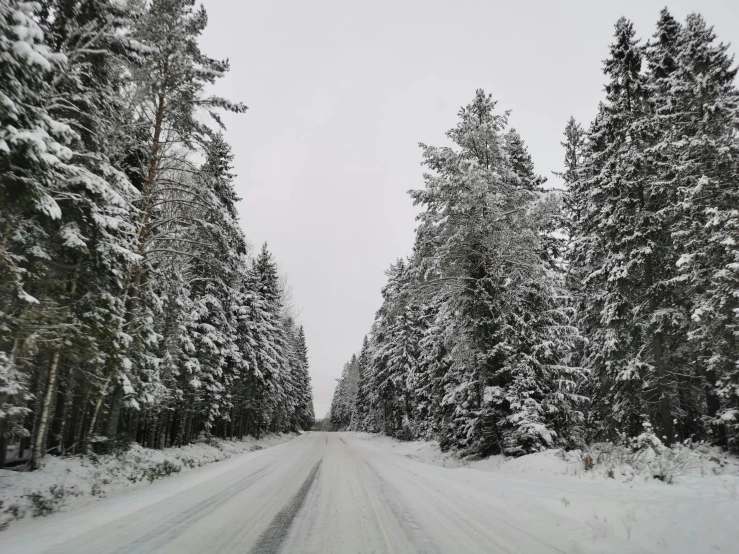 a dirt road that has snow on the ground