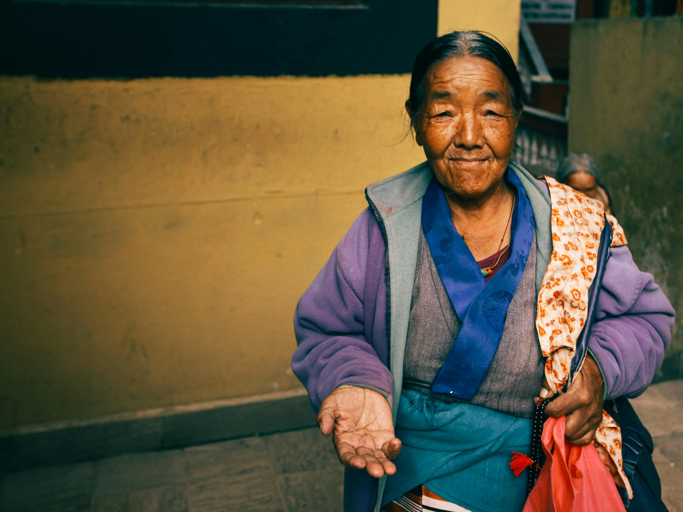 an old woman with a bag on her back