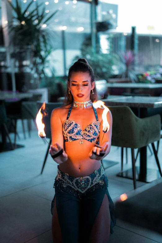 a woman standing on the street with flames on her