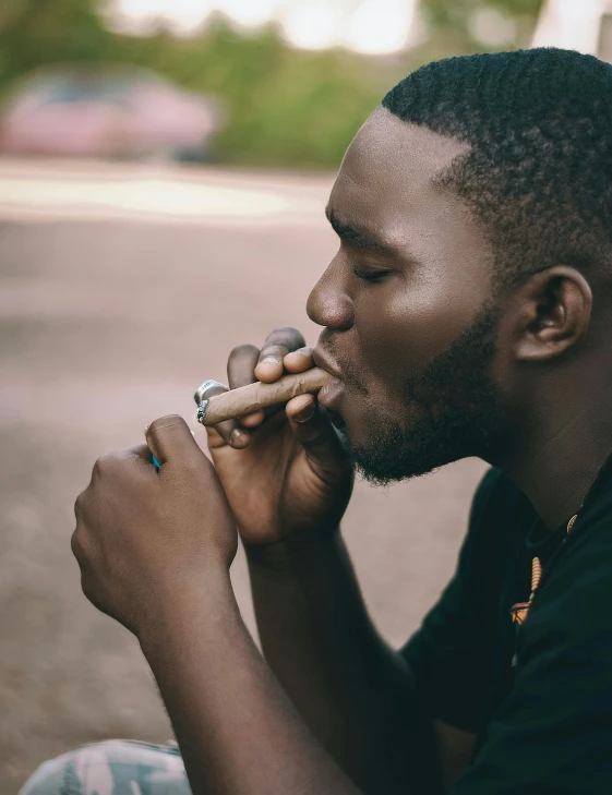 a person with his eyes closed and a ring in his mouth