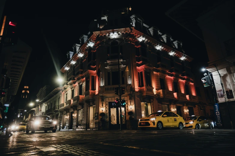 a building is lit up with red lights at night