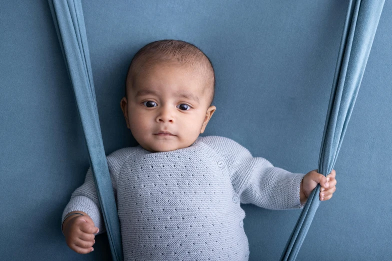 a baby that is sitting down in some blue pants