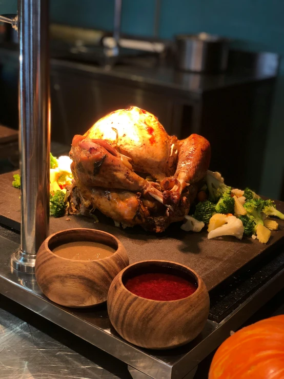 a large roasting turkey with spices in small wooden bowls