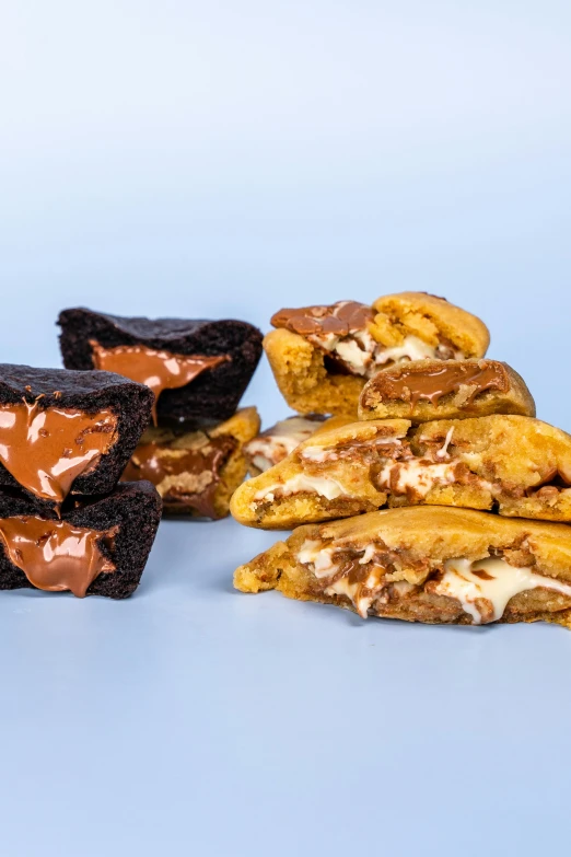 several different desert treats sitting together on a blue background