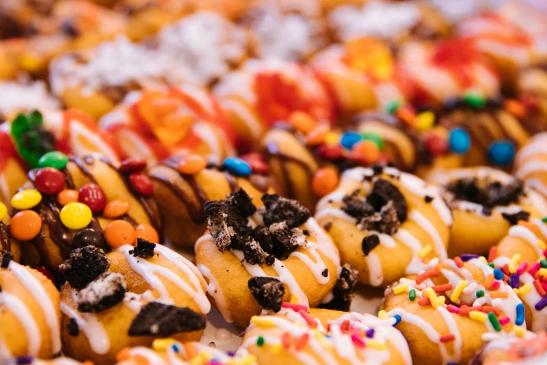 colorful candy donuts with white frosting and sprinkles