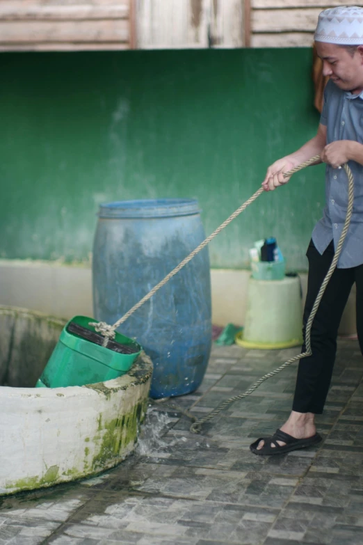 a man pulling a rope with his feet