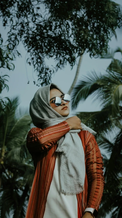 a man wearing a scarf and sunglasses