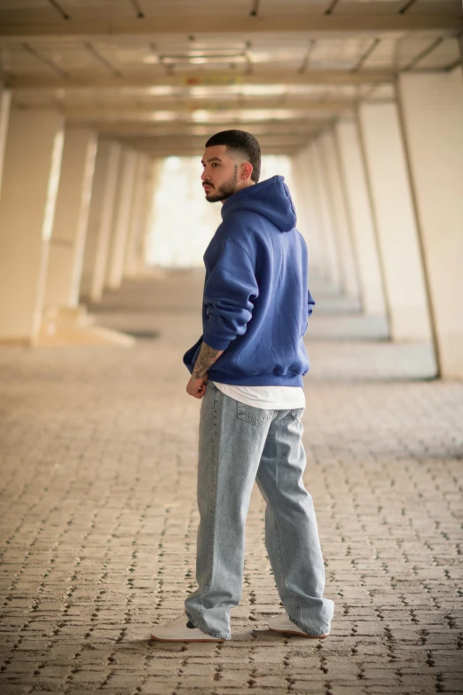 a man is standing in the middle of an alley way