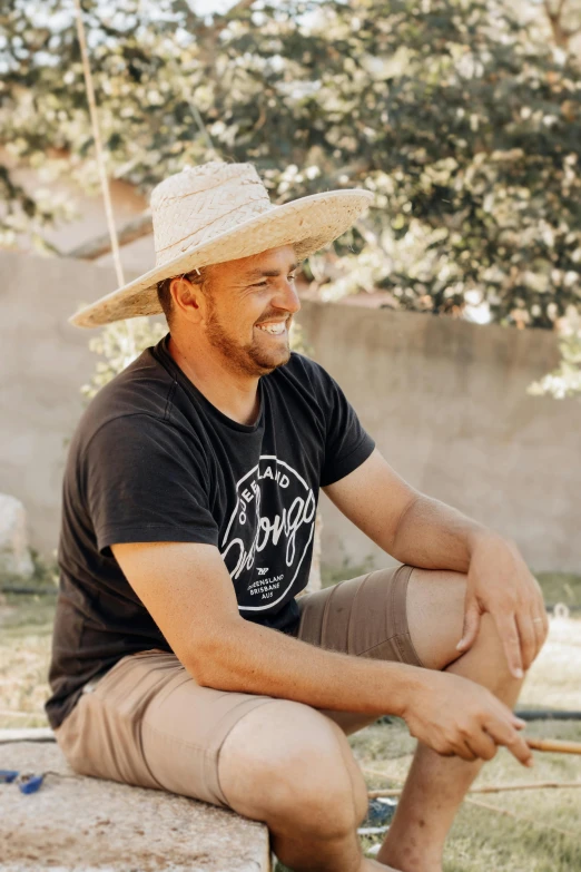 a man sitting on a bench and looking off into the distance