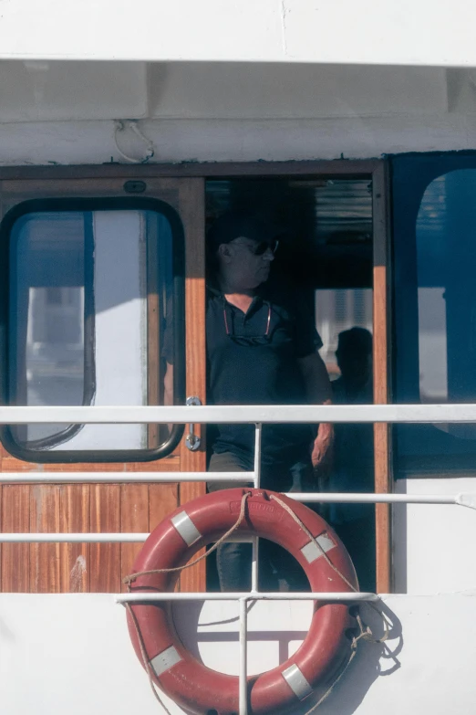 man in black jacket and life preserver entering boat